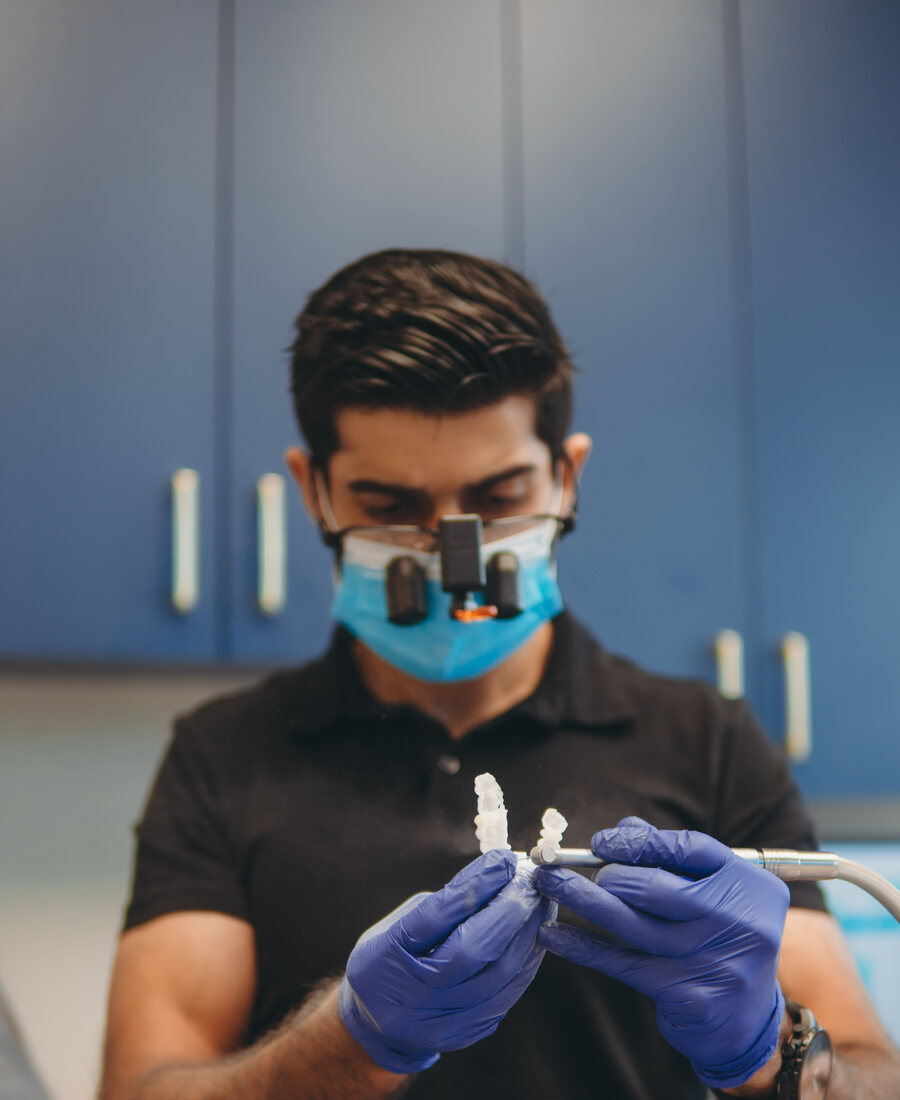 Dr. Omair Khan treating a patient at Khan Dental Studio in Mansfield
